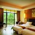 Yushuigu Hot Spring Hotel in Maoming guest room with two beds and balcony garden view