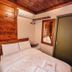 Pousada Charm Canela room in Canela with double bed, wood-paneled walls, mirror and wall AC