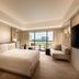 Conrad Singapore Orchard in Singapore guest room with king bed, city view, and seating area