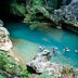 Ka'ana Resort, San Ignacio: guests floating in a turquoise natural pool surrounded by rocks and greenery