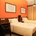 Big Hotel Suites, Mandaue City guest room with two twin beds, desk, curtains and wall art