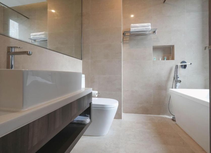 Amrise Hotel Kitchener bathroom with bathtub, toilet, and walk-in shower in Singapore
