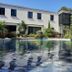 Hpc Suites Cassis poolside terrace with lounge chairs, plants, and stone building reflections in the water