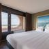 Leonardo Hotel Ijmuiden Seaport Beach room with large bed and sea view through round window in IJmuiden