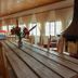 Chateau D'eau Hotel Faraya dining room with long wooden table and fireplace beside large windows
