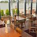Wherry Hotel Lowestoft restaurant with waterfront view, wooden tables and chairs by large windows