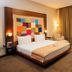The Landmark Hotel Baku guest room with king bed, floor-to-ceiling window and TV
