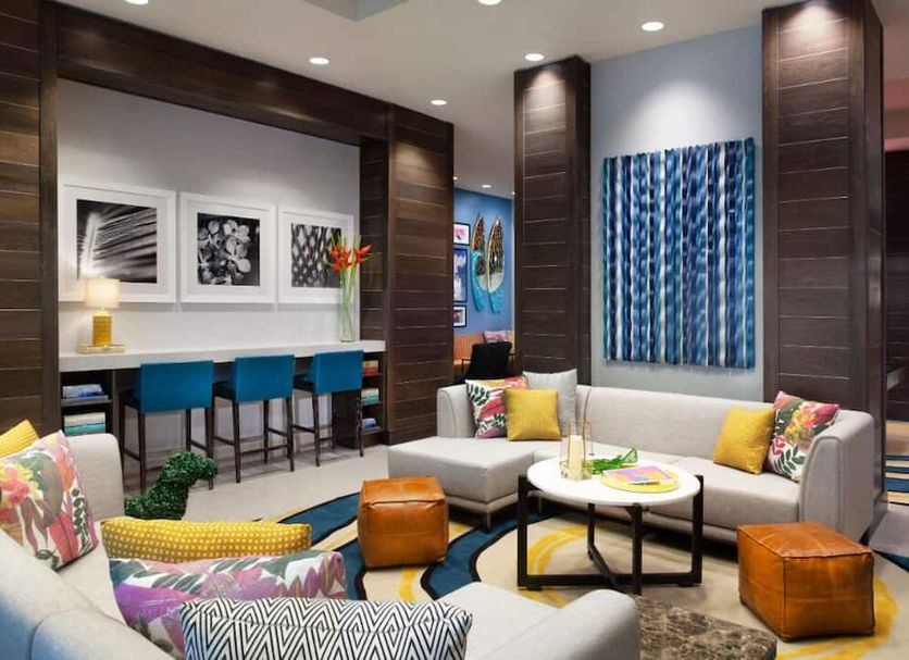 Homewood Suites by Hilton Miami Dolphin Mall lounge with colorful seating and bar stools in Miami