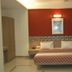 The Unicontinental - Campus Accommodation in Mumbai guest room with double bed and red accent wall