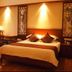 Sanqingshan Jinshawan Holiday Hotel Shangrao guest room with king bed and warm wood decor