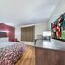 Red Roof Inn & Suites Denton guest room with king bed, desk, and wall-mounted TV in Denton