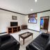 S&C Hotel Suites and Apartments in Koror living room with black leather sofas and TV