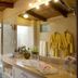 La Mirage Garden Hotel And Spa bathroom with double sink, walk-in shower and yellow bathrobes in Cotacachi