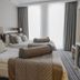 Seven Deep Hotel Ankara guest room with twin beds, pillows, and floor-to-ceiling window curtains