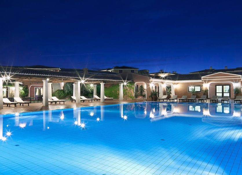 I Giardini di Cala Ginepro Hotel Resort in Cala Liberotto, lit outdoor pool at dusk