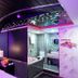 Cupid Hotel, Ho Chi Minh City: neon-lit room with tufted bed, mirrored ceiling, and open bathroom