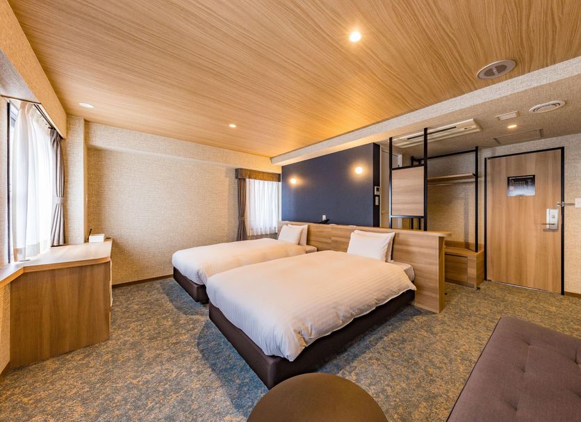 Fukuoka Toei Hotel in Fukuoka guest room with two twin beds and wood-paneled ceiling