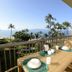 Mana Kai Maui in Kīhei balcony with table setting and ocean, palm tree, and beach views
