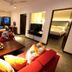 Hikka Tranz By Cinnamon in Hikkaduwa: spacious suite with red sofas, coffee table and balcony sea view