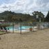 Garden Motor Inn in Gundagai: outdoor pool with lounge chairs, lawn seating and hillside views
