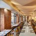 H+ Hotel Wien in Vienna breakfast buffet dining room with long tables and brick wall