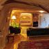 Anitya Cave House in Ürgüp cave-style room with sofa, bed alcove, and rustic stone interior