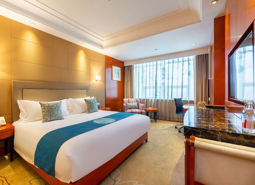 Yiwu Hotel (International Trade City) room in Jinhua with king bed, window seating and marble desk