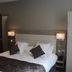 Hotel Restaurant L'esturgeon, Poissy: modern hotel bedroom with king bed, bedside lamps and wardrobe