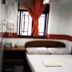 Woodstock Hostel Hong Kong guest room with twin beds, desk and window with red curtain