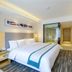 City Youpin Pro Hotel Shantou guest room with king bed, desk, TV, and glass-enclosed shower