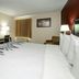Red Roof Inn Hillsville guest room with king bed, TV, desk, chair and window with curtains