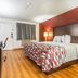 Red Roof Inn Phoenix-Midtown room with king bed, desk, TV and wood-look flooring in Phoenix