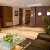 Appart City Le Blanc Mesnil lobby with reception desk, seating area and potted plants in Le Blanc-Mesnil
