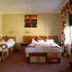 Station Hotel And Restaurant, Melrose: twin beds in a guest room with window curtains and wall art