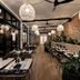The Clements Hotel in Cambridge restaurant with wicker pendant lights, brick wall and indoor seating