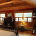 Kiwassa Lake Bed & Breakfast in Saranac Lake guest room with wood ceiling, fireplace, and lake-view windows