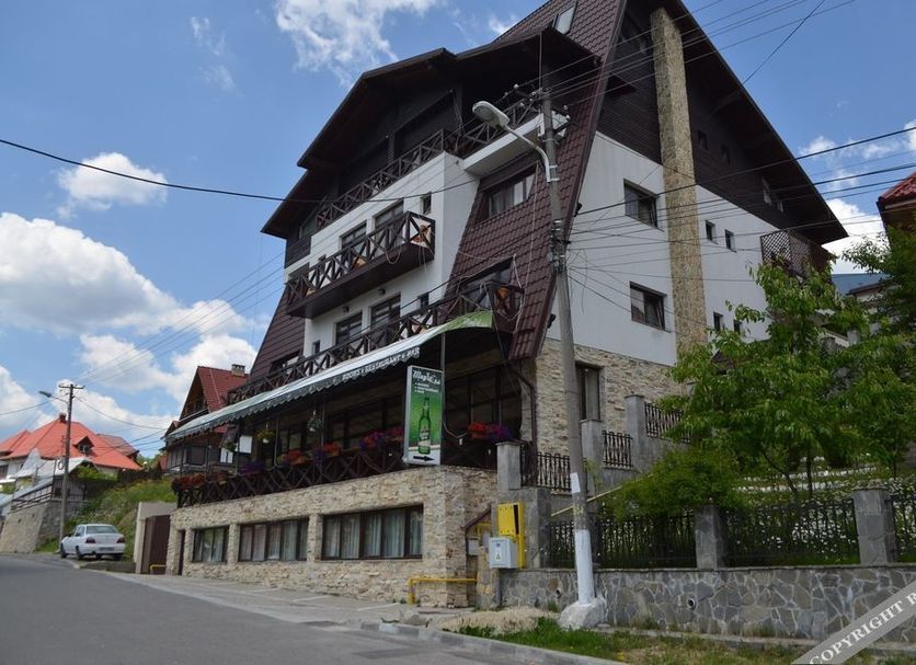 Magic Club in Bușteni, alpine-style hotel exterior with balconies and sloped roof