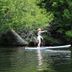 Kiwassa Lake Bed & Breakfast in Saranac Lake: guest paddleboarding on a calm lake