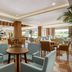 Wyndham Garden Lara Antalya lobby lounge with seating and dining area, bright open interior