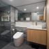 Il Palazzo Holiday Apartments Cairns bathroom with glass shower, toilet, vanity and mirror