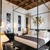Hotel Casa Palacio Don Ramón in Seville: elegant four-poster bed in a stylish guest room