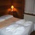 Pousada Raposa Vermelha room in Gramado with a bed, bedside lamp, window and radiator