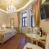 Central Square Heritage Hotel Split room with chandelier, king bed, and large windows