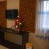 Phu Chom Mork Resort in Sangkhla Buri room with wall-mounted TV, console, minibar and floral decor