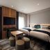 The Knot Tokyo Shinjuku room with twin beds, TV, stools and desk in Tokyo