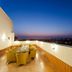 Ginger Jaipur rooftop terrace with seating and city skyline views at dusk