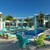 Margaritaville Island Reserve Riviera Cancun pool deck with turquoise loungers and colorful chairs in Puerto Morelos