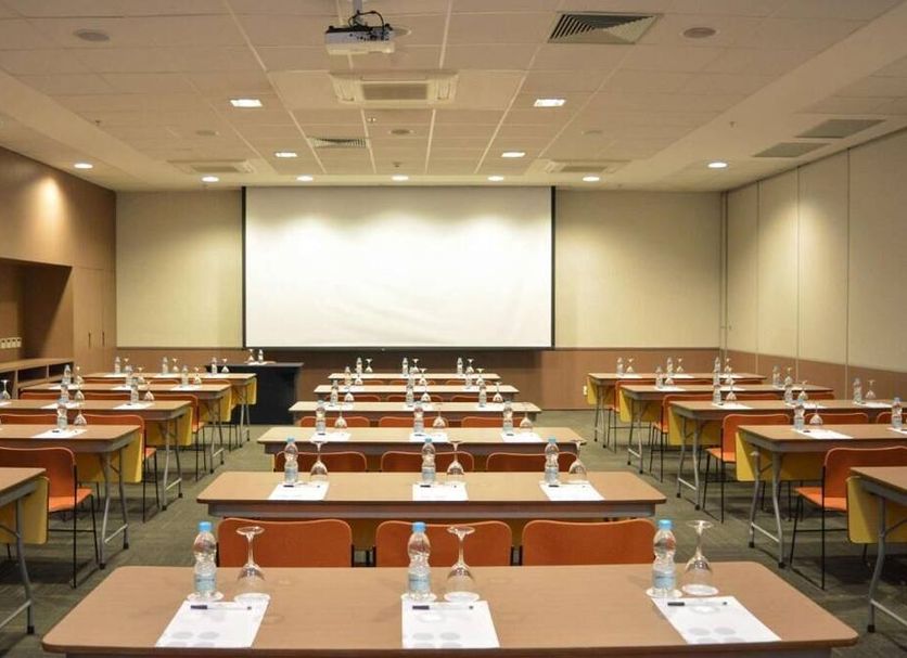Regency Barra Hotel in Rio de Janeiro conference room with rows of tables and projector screen