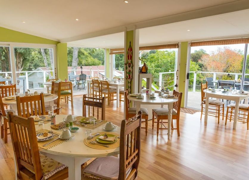 Stannards Guest Lodge in Knysna dining room with large windows and garden views