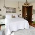 Shadowcrest in Fleischmanns: bedroom with king bed, chandelier, wood doors and hardwood floors